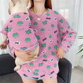 A person holds a dog, both wearing matching pink fabric sweatshirts with a green cactus pattern and Jazz and WOW! text.