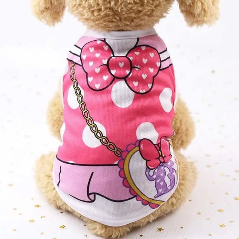 Pink mesh dog vest with white polka dots, a red heart bow, and a printed purse graphic on a small tan dog.