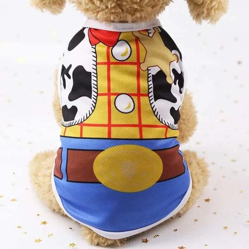 Small dog wearing a mesh vest with a yellow plaid, cow print, and blue denim cowboy outfit design.