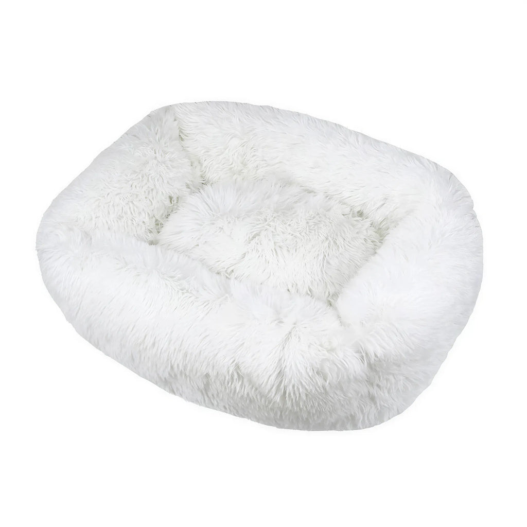 White rectangular plush fabric dog bed with a shaggy texture and raised bolster edges.