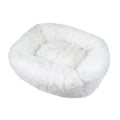 White rectangular plush fabric dog bed with a shaggy texture and raised bolster edges.