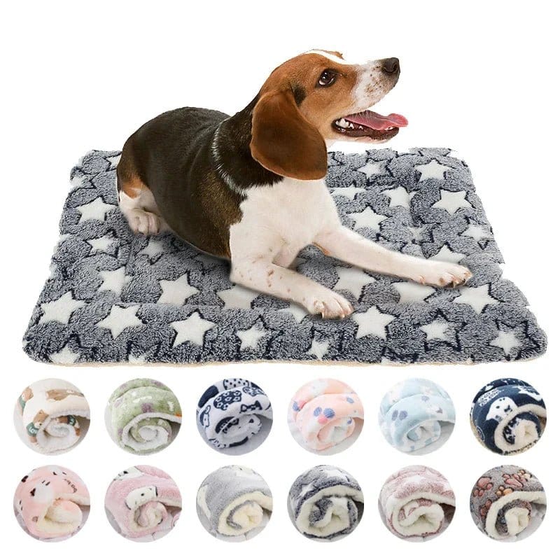A dog lying on a gray and white star-patterned fleece dog mat.
