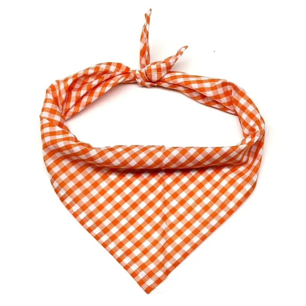 One orange and white checkered fabric dog bandana tied in a knot on a white background.