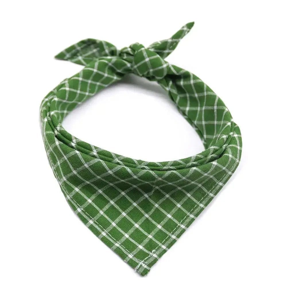 Green fabric dog bandana with a white grid pattern, tied in a knot on a white background.