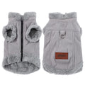 Front and back views of a grey corduroy dog vest with fleece lining, a black zipper, metal D-ring, and a brown logo patch.