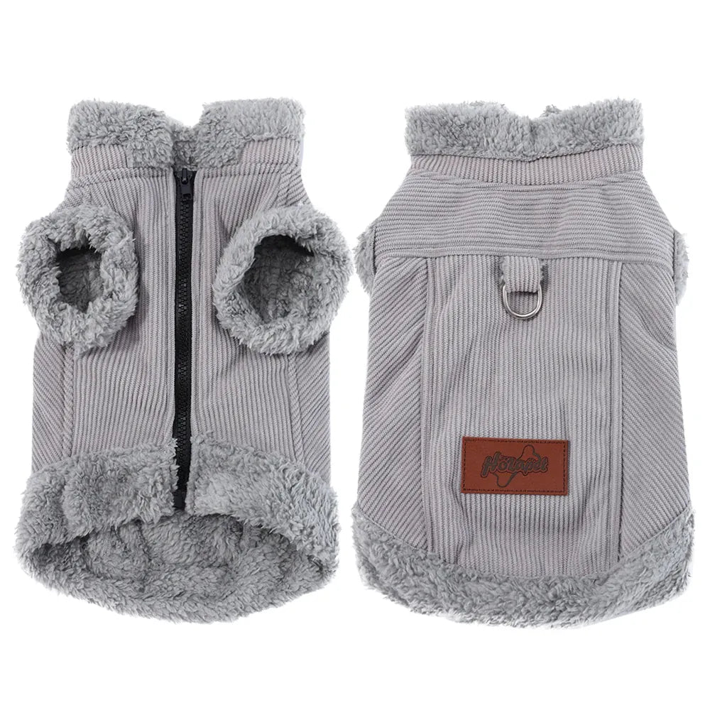 Front and back views of a grey corduroy dog vest with fleece lining, a black zipper, metal D-ring, and a brown logo patch.