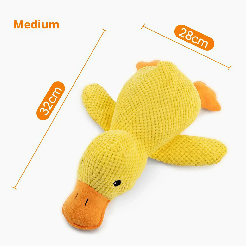Yellow textured fabric duck dog toy with orange beak and feet. Text indicates Medium size, 32cm by 28cm.