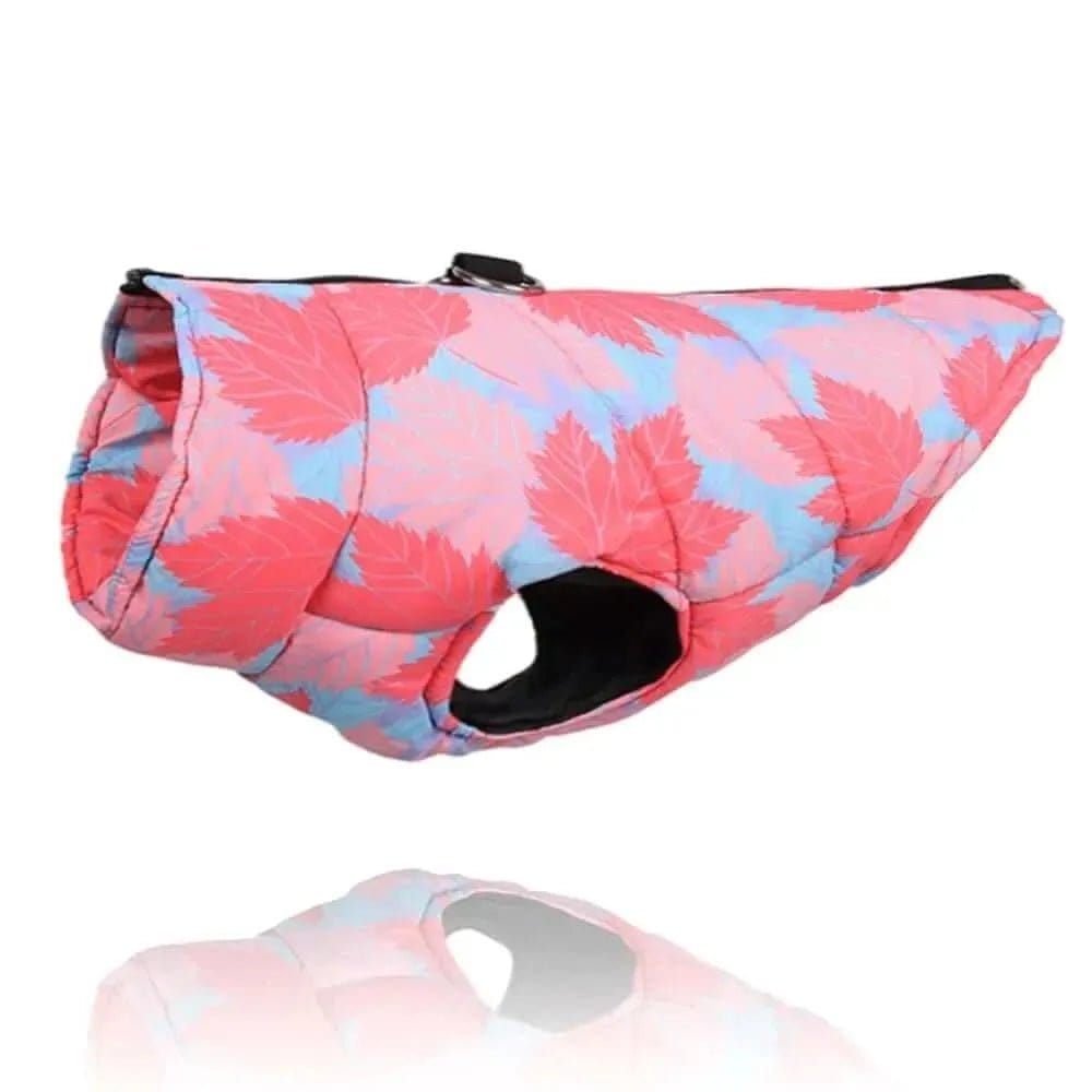 Pink and blue leaf pattern padded dog jacket with a harness ring on top.