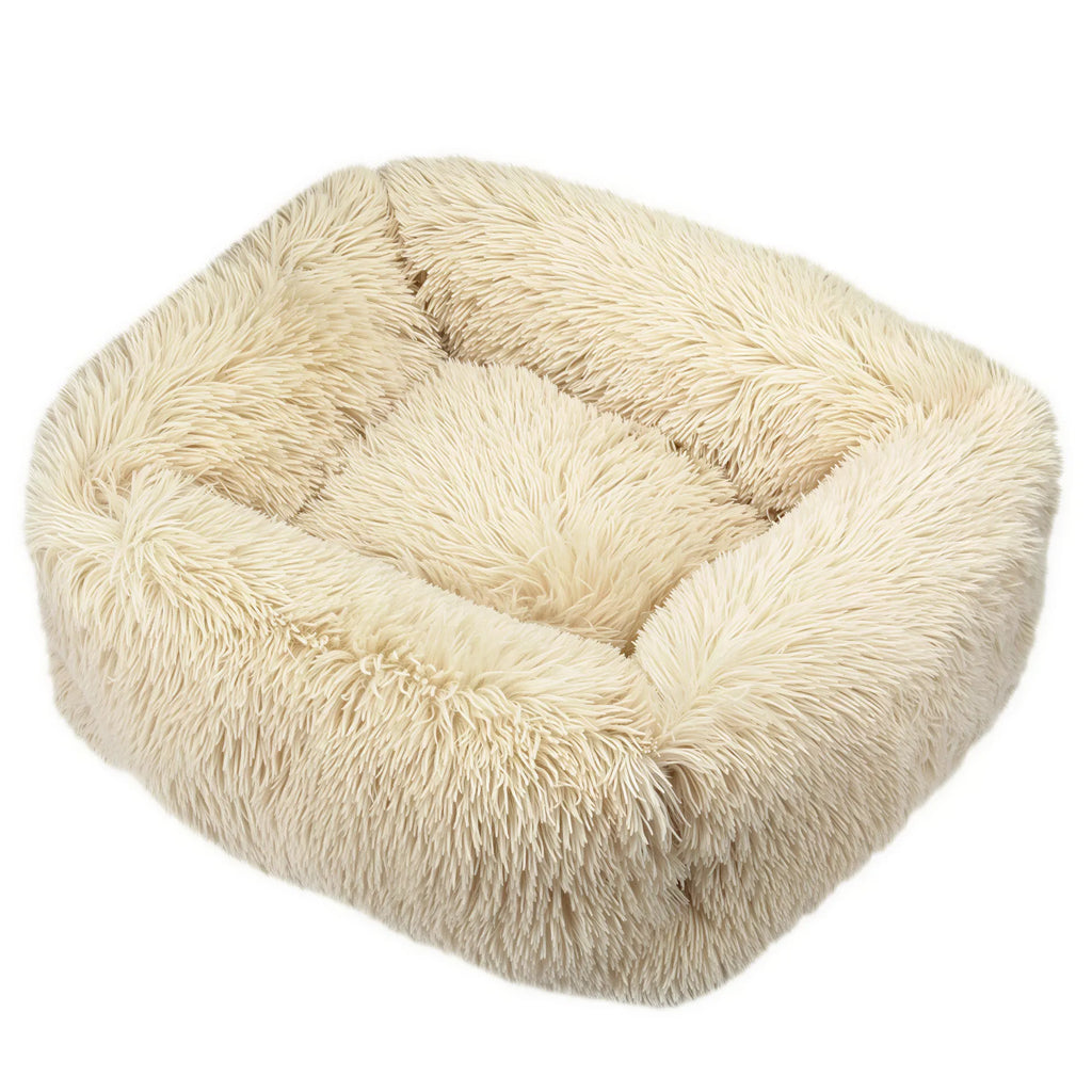 One square cream fabric pet bed with a shaggy plush texture and raised bolster sides.