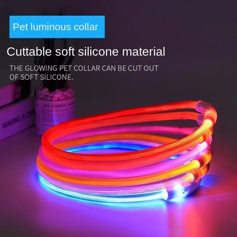 A collection of colorful glow in the dark dog collars made from soft silicone material, displayed in a stack with text highlighting the pet collar's features.