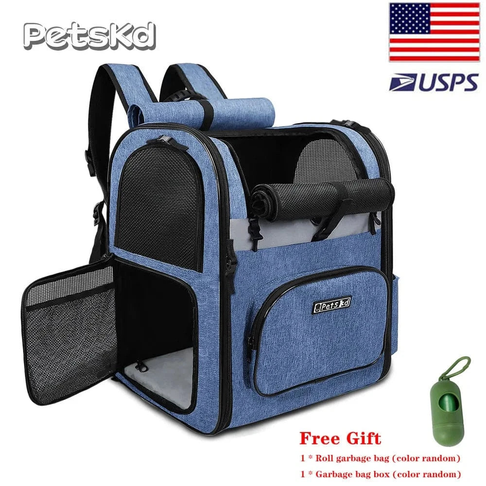 A blue dog shoulder carrier with mesh windows and adjustable straps. The carrier is designed to be worn on the shoulders and has a front opening.