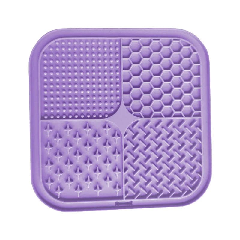 A purple LickiMat Buddy designed for pets, with a maze-like pattern intended for dispensing soft treats.